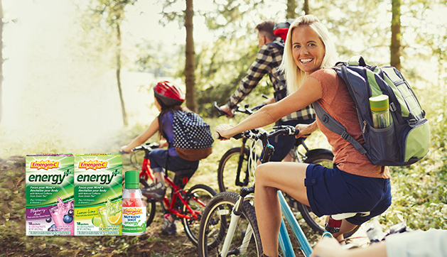 Emergen-C Energy Plus products. A group of people biking with the woman looking back and smiling.