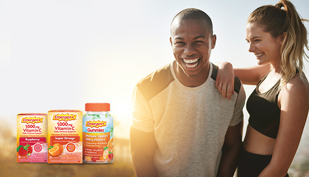 Emergen-C Vitamin C products. A man and woman smiling, wearing athletic clothing.