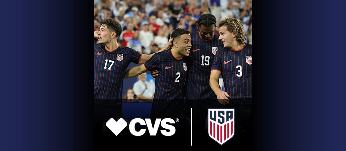 Four members of the men’s U.S. Soccer team celebrate a goal. CVS logo and U.S. Soccer logo are featured at the bottom right of image.