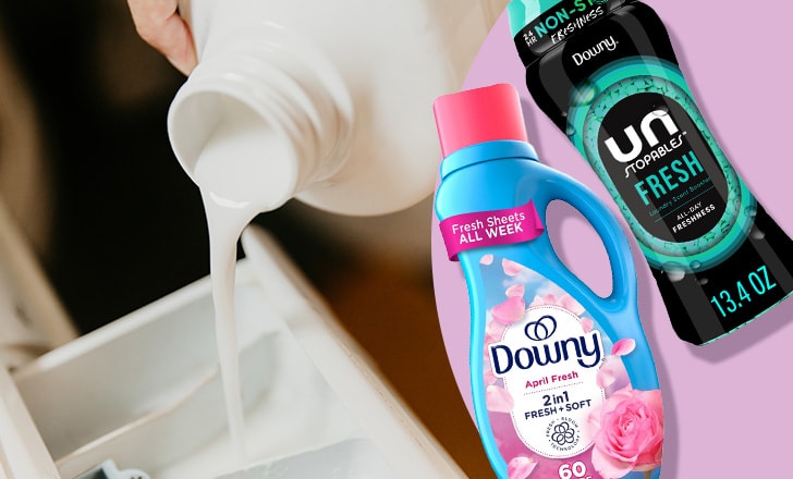 Close up of laundry pouring into a washing machine next to Downy April Fresh fabric softener and Unstopables Fresh scented beads